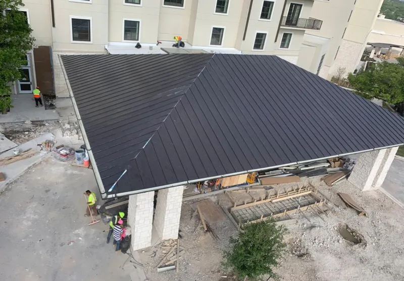 Metal roofing installation team working on a commercial building in Amarillo